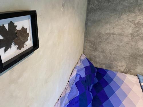 a bed in a room with a picture on the wall at BeachBox@Koh Сhang in Ko Chang