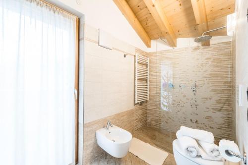a bathroom with a sink and a toilet and a shower at Cèsa Baissa in Campitello di Fassa