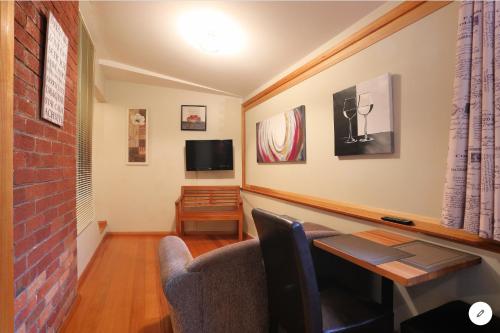 a living room with a couch and a table at NORD - North Hobart Apartments in Hobart