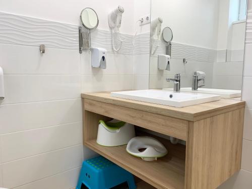 a bathroom with a sink and a mirror at Mese Panzió Zalakaros in Zalakaros
