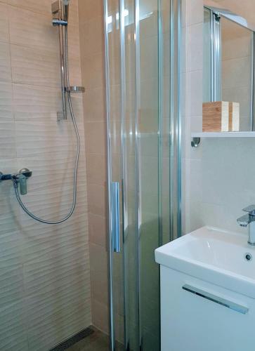 a bathroom with a shower and a sink at Apartmani Elena in Malinska