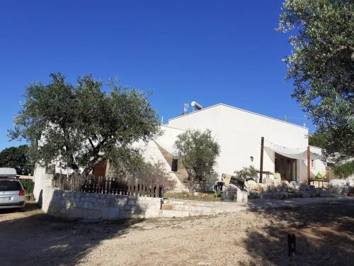 una casa blanca con una valla delante en B & B Monte Adamo, en Conversano