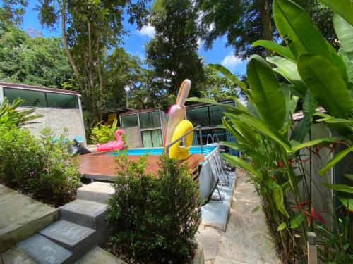 a backyard with a pool with two plastic animals on it at BeachBox@Koh Сhang in Ko Chang