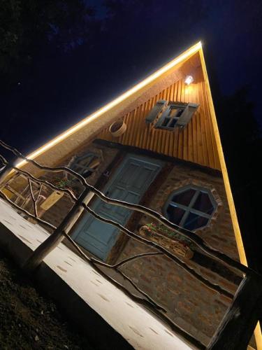 a building with a street light in front of it at Etno Village Dolina Sreće in Vitez