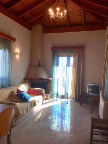 a large living room with a couch and a television at Cosy Country Villa in Pappayiannádhes