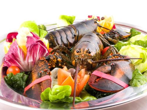 a plate of food with lobsters on a salad at La Vigna Hotel in Bonea