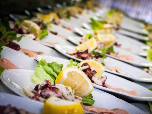 a row of plates of food on a table at La Vigna Hotel in Bonea
