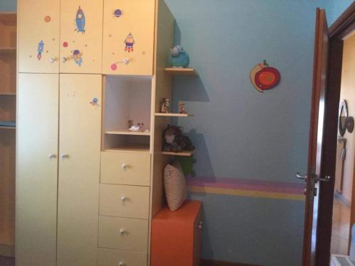 a childs bedroom with a white cabinet and a rainbow at Cosy Country Villa in Pappayiannádhes