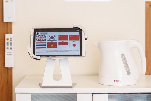 a tablet computer on a stand next to a blender at Yufu-no-yu Shiki Iyashi in Yufuin