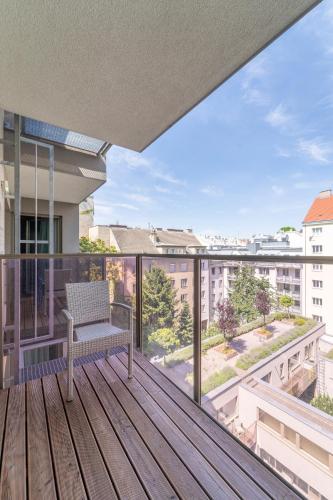 a balcony with a bench on a wooden deck at Pakat Suites in Vienna