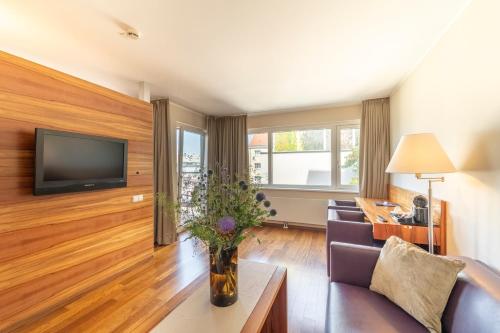 a living room with a couch and a tv at Pakat Suites in Vienna