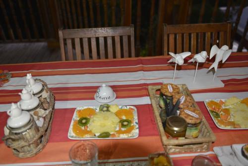 a table with a plate of food on it at Villa Des Remparts in Sainte-Marie