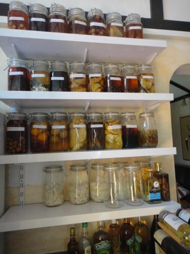 a refrigerator filled with lots of jars of food at Villa Des Remparts in Sainte-Marie