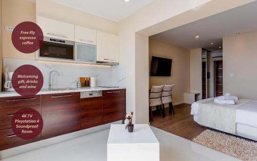 a kitchen and a bedroom with a bed and a room with a kitchen at Villa Višnja in Brela