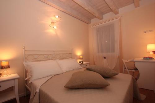 a bedroom with a bed with two pillows on it at Il Conte in San Bonifacio