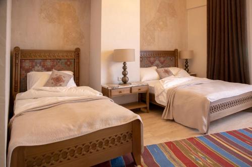 מיטה או מיטות בחדר ב-Boutique ETHNO HOTEL