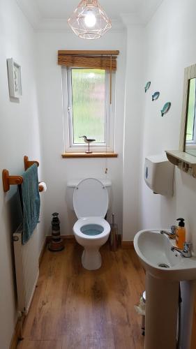 a bathroom with a toilet and a sink at The Curling Pond, Dalmally Road, Inveraray in Inveraray