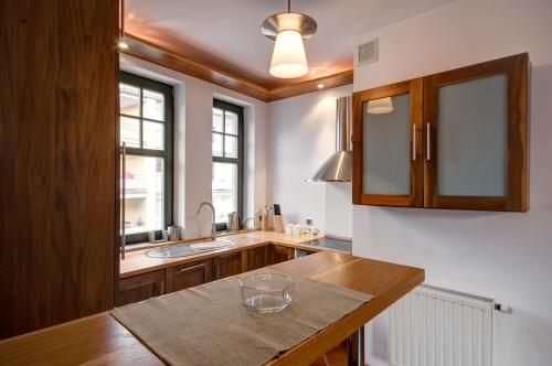 a kitchen with a wooden counter and a sink at Apartament Haffnera 10 in Sopot