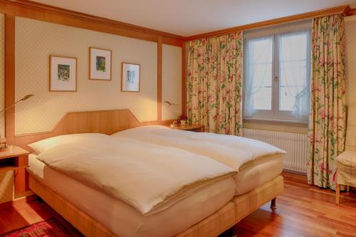 Ein Bett oder Betten in einem Zimmer der Unterkunft Romantik Hotel Säntis