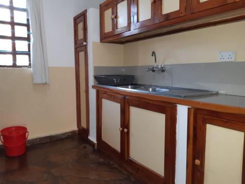 a kitchen with a sink and a counter top at Eden House Cottages in Malindi