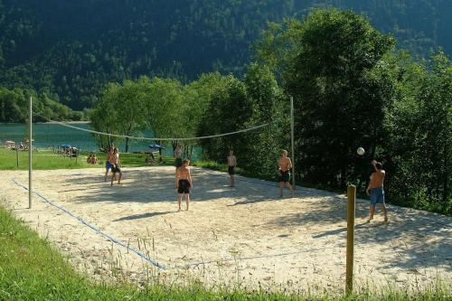 a group of men playing volleyball on a beach at Haus Hirschpoint in Faistenau