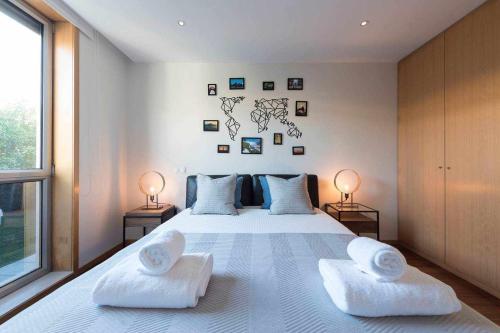 a bedroom with a large white bed with two pillows at Brunos Beach House in Lavra