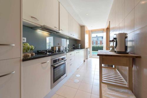 a large kitchen with white cabinets and a counter top at Bruno's Beach House in Lavra