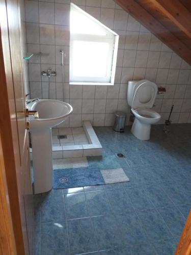 a bathroom with a sink and a toilet at Ostria Seaside Apartments in Patra