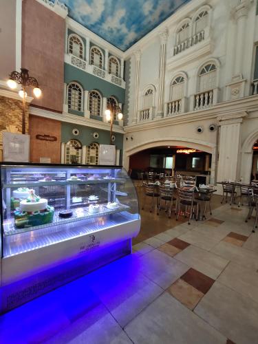 a large room with a display case in a restaurant at Regenta Inn Vadodara, 500m from Railway Station in Vadodara