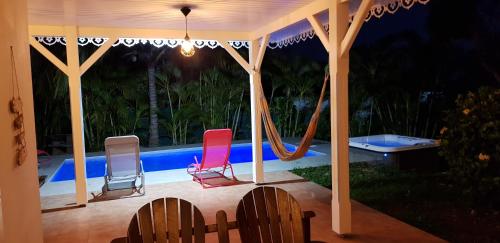 a group of chairs sitting under a gazebo at Villa Bois d'Inde in Le Diamant
