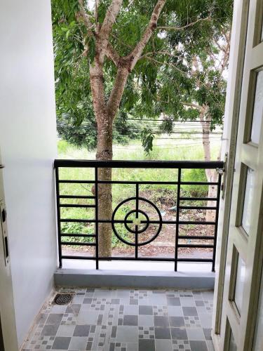 a door leading to a porch with a tree at Khách sạn Kim Phụng Ngân in Can Tho