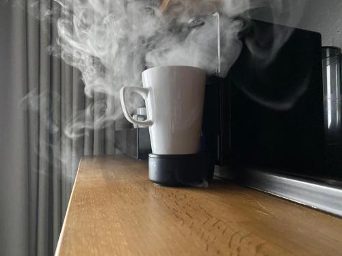 a cup with smoke coming out of it on a table at The Baltic Hotel in Liverpool
