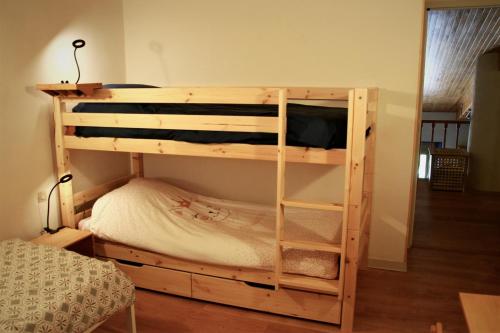 Ce lit superposé en bois se trouve dans un dortoir. dans l'établissement Le Nid des Combes, à Dunières-sur-Eyrieux