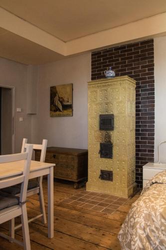 a room with a bed and a brick wall at U Černého kocoura a zeleného stromu in Tábor