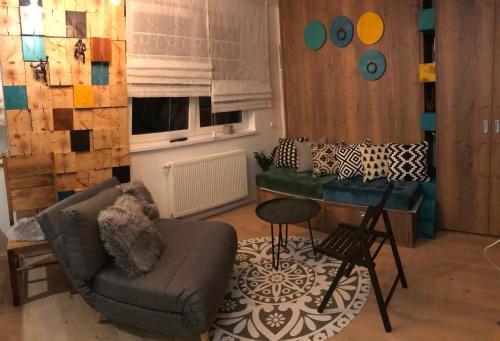 a living room with a couch and a table at Olimpijska kuca Jahorina - Apartman A708 in Jahorina