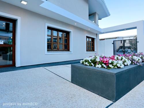 a building with two flower boxes in front of it at Hotel Nettuno in Cala Gonone