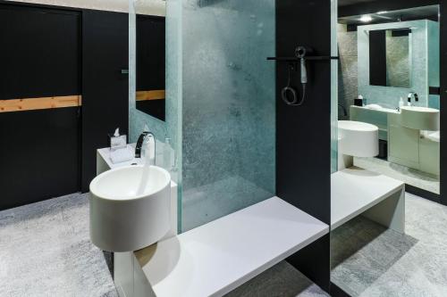 a bathroom with a sink and a shower at Au Club Alpin in Champex