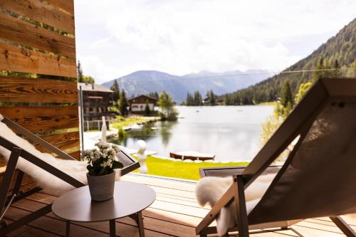 a balcony with a view of a lake and mountains at Au Club Alpin in Champex