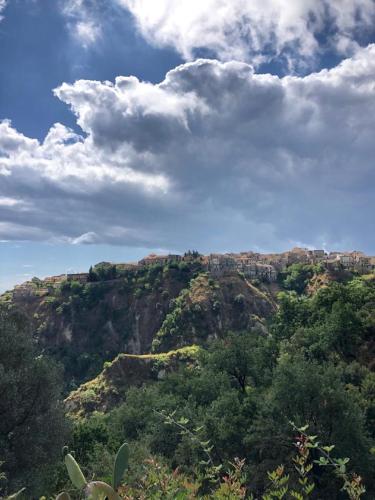 a view of a mountain with trees and clouds at Santa Caterina dello Ionio Boutique Apartments in Santa Caterina dello Ionio