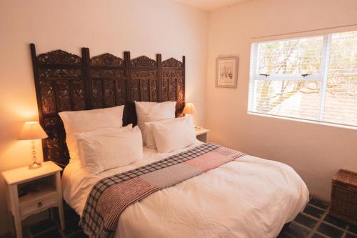 a bedroom with a large bed with white sheets and pillows at Pringle Beach House in Pringle Bay