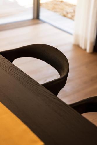 a close up of the back of a black chair at Au Club Alpin in Champex