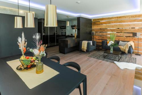 a dining room and living room with a table and chairs at Au Club Alpin in Champex