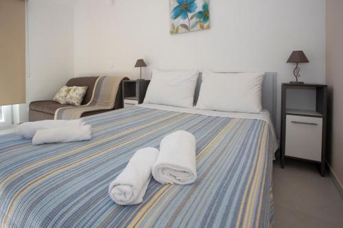 a bedroom with a bed with towels on it at Apartments Medvidovic in Baška Voda