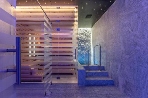 a staircase in a house with purple lighting at Au Club Alpin in Champex