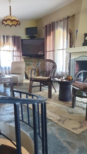 a living room filled with furniture and a fireplace at Casa del mare ex Exohiki Katoikia in Paralia Katerinis