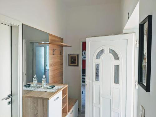 a bathroom with a sink and a white door at Glorianita sweethome,centro, FREE parking,SELF CHECK- IN in Šibenik