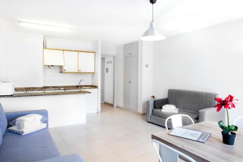 a living room with a couch and a table at Abelletes Apartments in Pas de la Casa