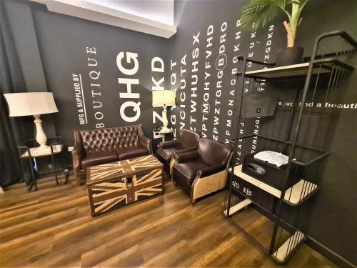 a living room with two chairs and a couch at M Boutique Hotel Station 18 - Ipoh in Ipoh