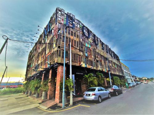 a large building with cars parked in front of it at M Boutique Hotel Station 18 - Ipoh in Ipoh