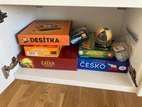 a shelf with a bunch of boxes on top at Apartmán MAAY in Hlohovec